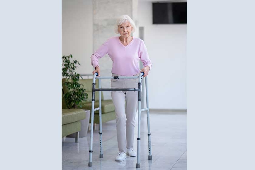 Elderly woman with a rolling-walker looking determined