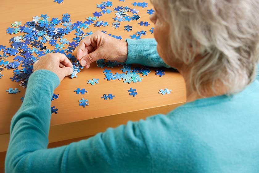 Mature woman doing puzzle