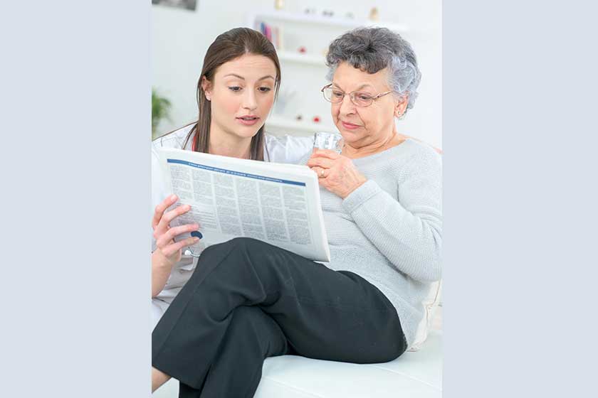 Reading a newspaper with an old lady